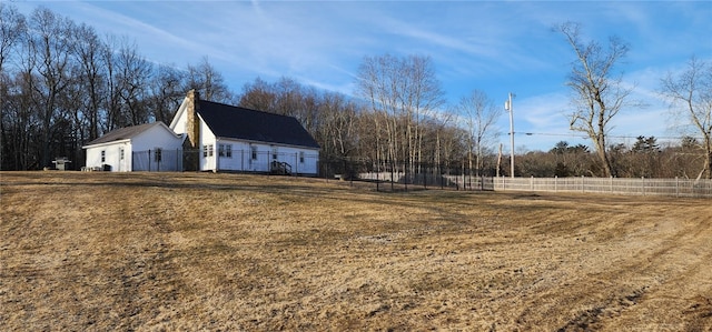 exterior space featuring an outbuilding, a barn, and fence