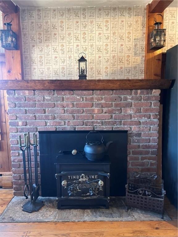 details featuring wallpapered walls, wood finished floors, and a fireplace