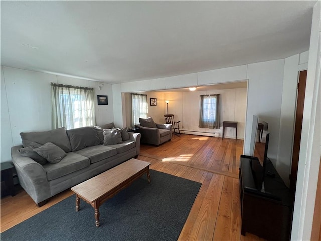 living room featuring light wood-type flooring and a baseboard radiator