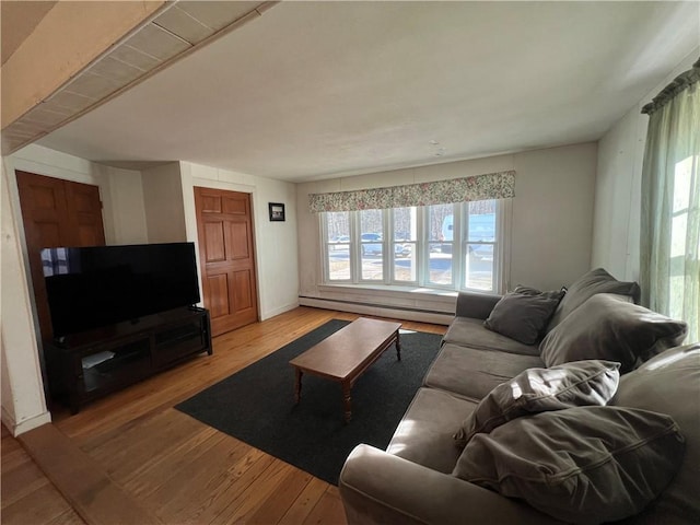 living room featuring wood finished floors, baseboards, and baseboard heating