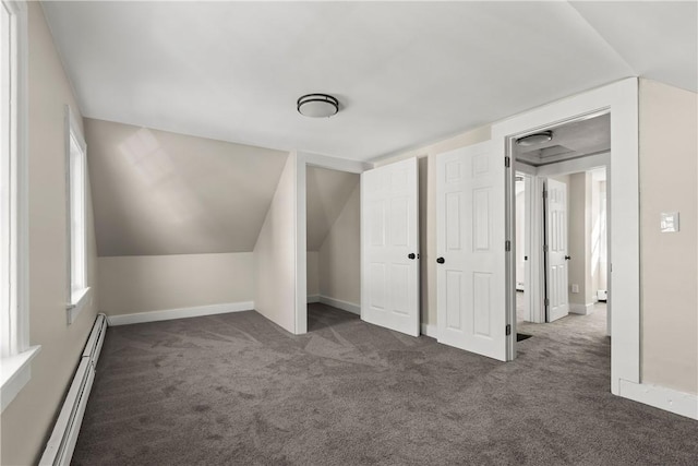 bonus room with baseboard heating, baseboards, and carpet