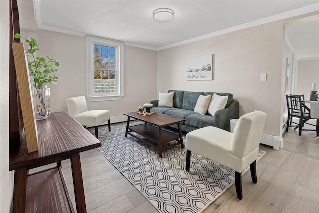 living room with light wood-type flooring, baseboards, and ornamental molding