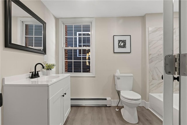 full bathroom featuring vanity, wood finished floors, baseboards, a baseboard radiator, and toilet