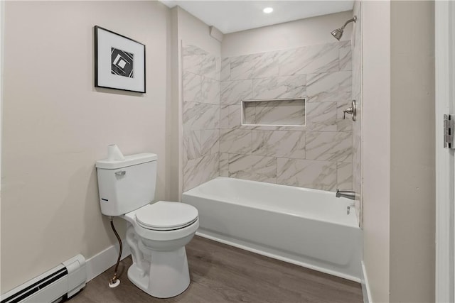 bathroom featuring toilet, a baseboard heating unit, wood finished floors, shower / bath combination, and baseboards