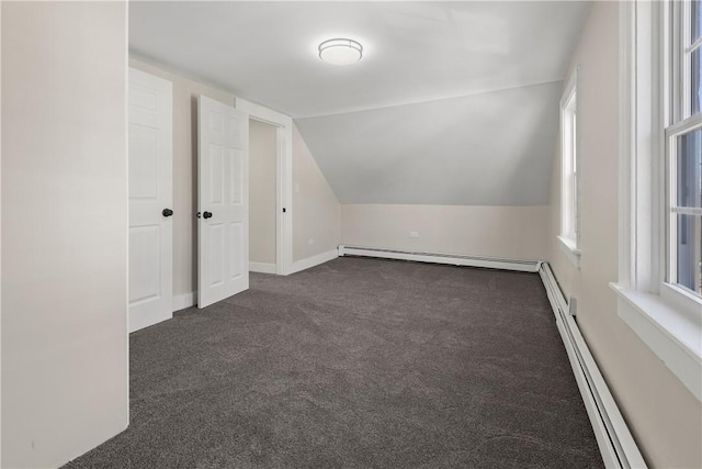 bonus room with baseboards, a baseboard radiator, vaulted ceiling, dark colored carpet, and baseboard heating