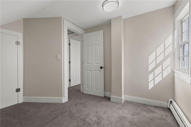 unfurnished bedroom with baseboards, baseboard heating, and carpet floors