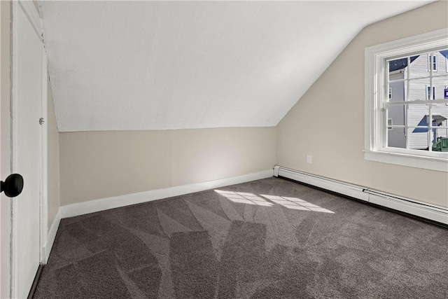 additional living space featuring lofted ceiling, carpet flooring, baseboards, and a baseboard radiator