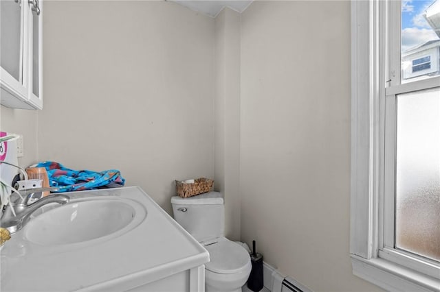 bathroom with plenty of natural light, toilet, and vanity