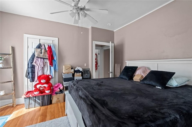 bedroom with wood finished floors and a ceiling fan