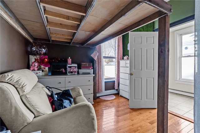 interior space with light wood-style floors and baseboard heating