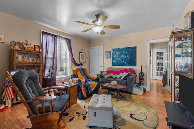 living area with ceiling fan and wood finished floors