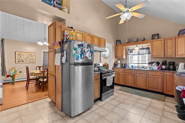 kitchen featuring under cabinet range hood, stainless steel appliances, brown cabinetry, and a sink