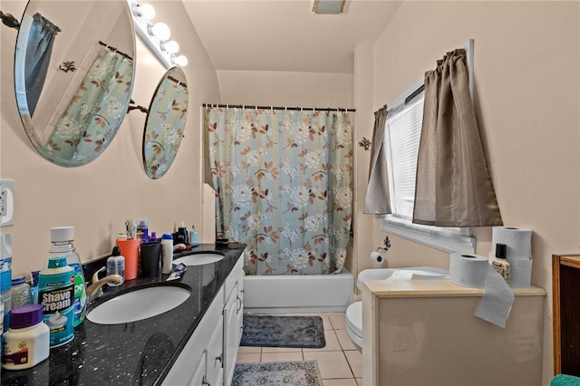 bathroom with tile patterned flooring, double vanity, shower / bath combo with shower curtain, and a sink