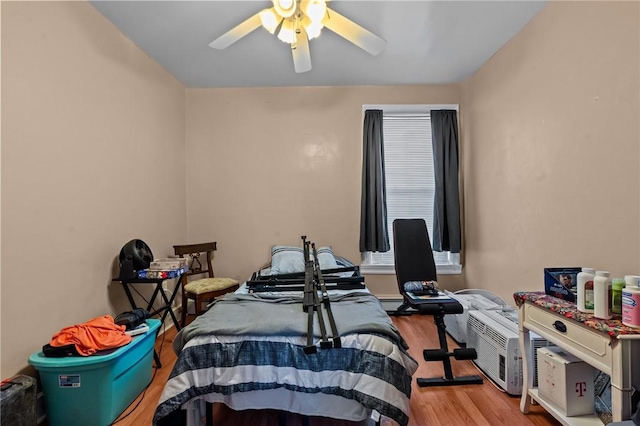 bedroom featuring a ceiling fan and wood finished floors