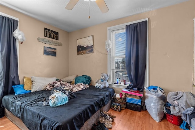 bedroom featuring ceiling fan and wood finished floors