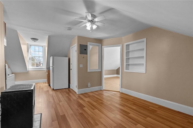 bonus room featuring electric panel, built in features, light wood-type flooring, and baseboards