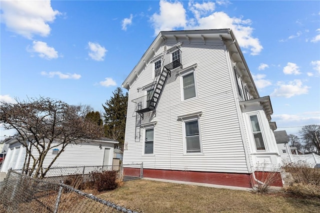 view of home's exterior featuring a yard and fence