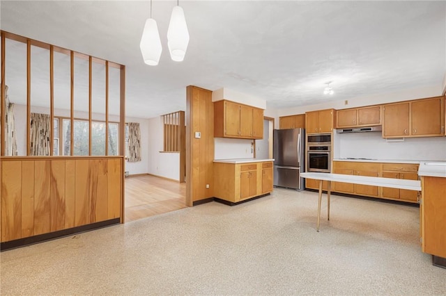 kitchen featuring under cabinet range hood, decorative light fixtures, light countertops, appliances with stainless steel finishes, and brown cabinetry