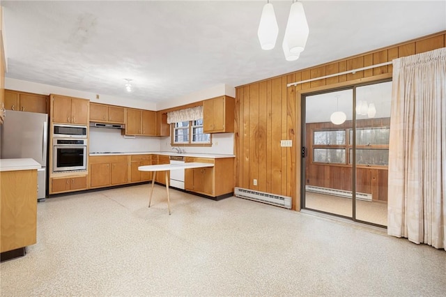 kitchen with stainless steel appliances, a baseboard heating unit, light countertops, and a baseboard radiator