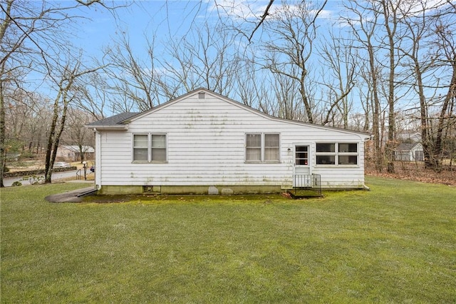 view of side of property with a yard