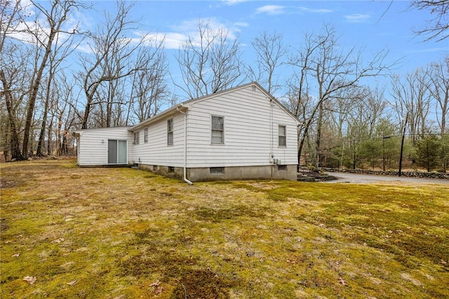 view of property exterior with a yard