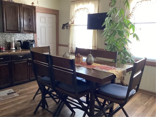 dining space with light wood-type flooring and a wealth of natural light