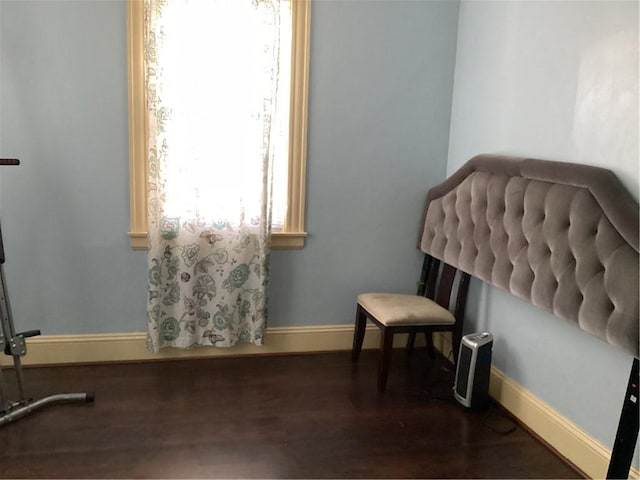 living area with baseboards and dark wood finished floors