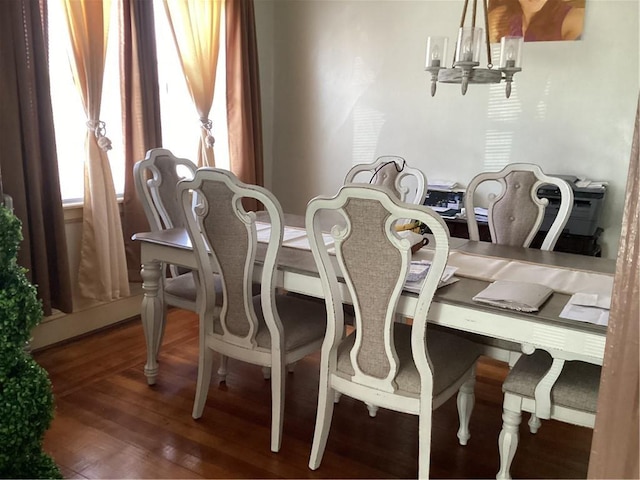 dining space with an inviting chandelier and wood finished floors