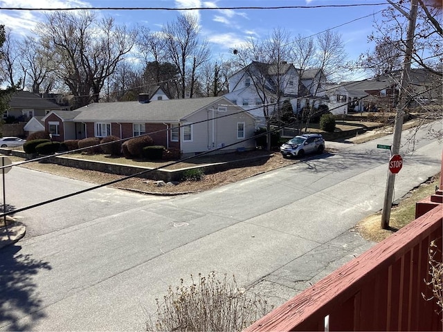 view of road featuring curbs and a residential view