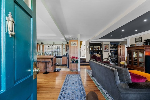 living area with stairway, recessed lighting, and wood finished floors