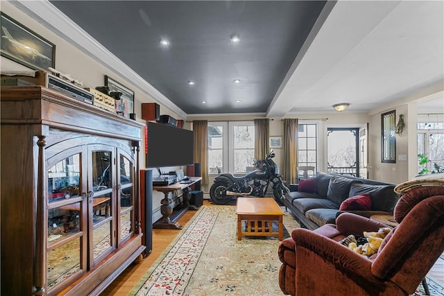 living room featuring recessed lighting, ornamental molding, and light wood finished floors