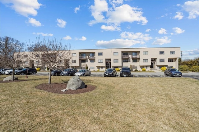 view of building exterior with a residential view and uncovered parking