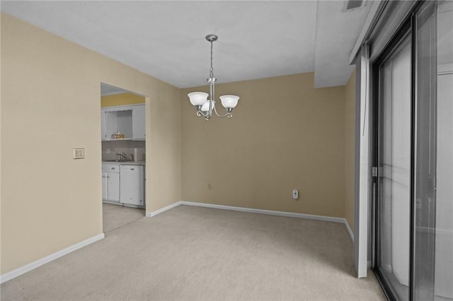 unfurnished room featuring a sink, a notable chandelier, baseboards, and light colored carpet