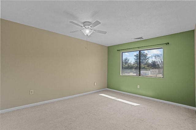 empty room with visible vents, ceiling fan, baseboards, and carpet