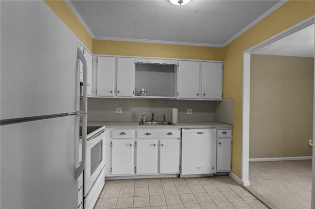 kitchen with light countertops, ornamental molding, white cabinets, white appliances, and a sink