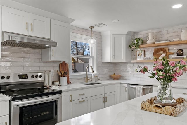 kitchen featuring visible vents, a sink, stainless steel appliances, light countertops, and under cabinet range hood