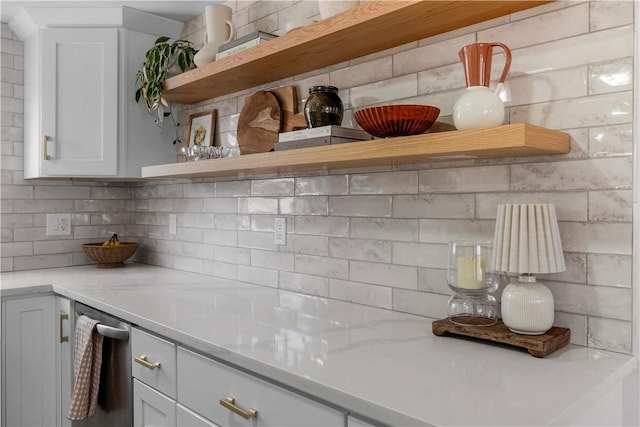 kitchen with backsplash, white cabinets, light countertops, and open shelves