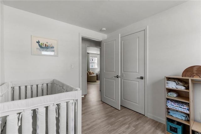 bedroom featuring wood finished floors and baseboards