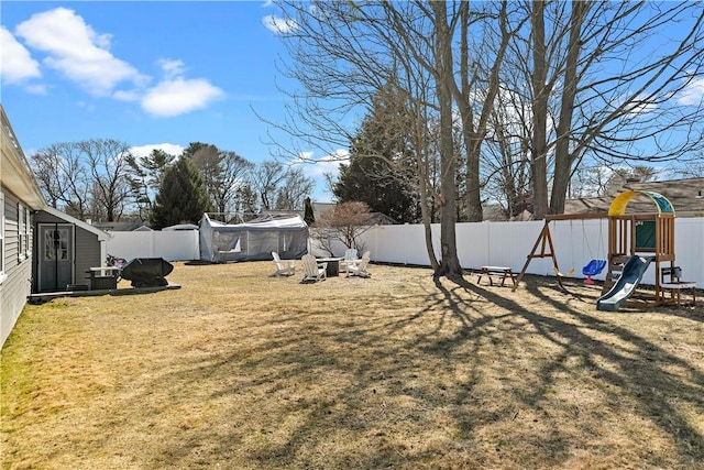 view of yard featuring a fenced backyard and a playground