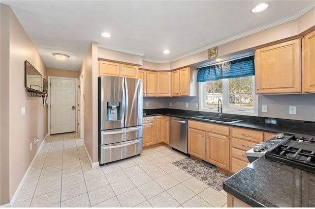 kitchen featuring light brown cabinetry, a sink, dark countertops, stainless steel appliances, and light tile patterned floors