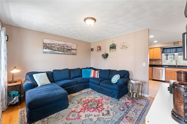 living area with light wood-style flooring, recessed lighting, and baseboards