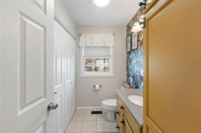 bathroom featuring vanity, visible vents, baseboards, tile patterned flooring, and toilet