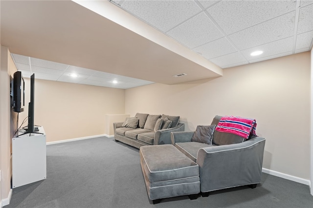 carpeted living area with a drop ceiling, visible vents, and baseboards