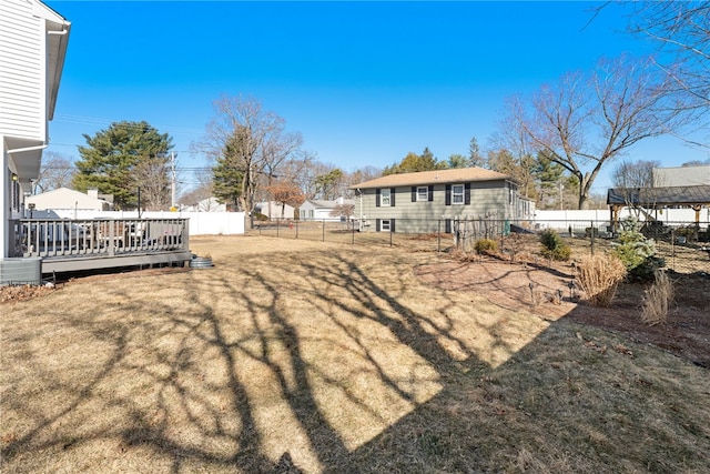 view of yard featuring a deck and a fenced backyard