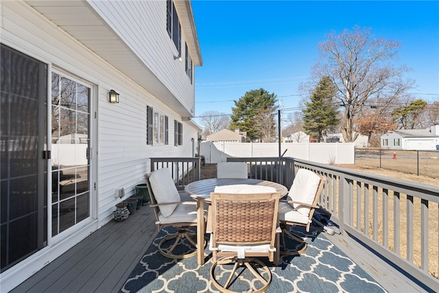 wooden terrace with outdoor dining space and fence private yard