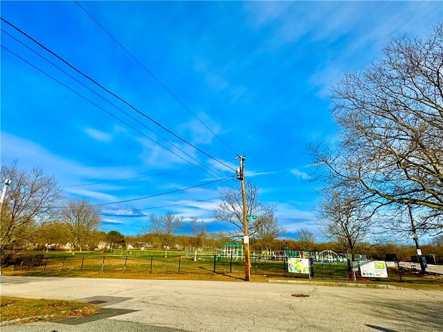 view of home's community with playground community and fence