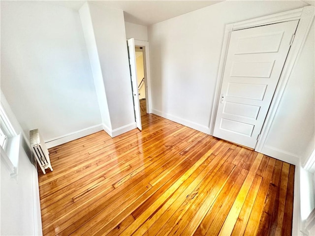 unfurnished bedroom featuring baseboards and light wood-style flooring