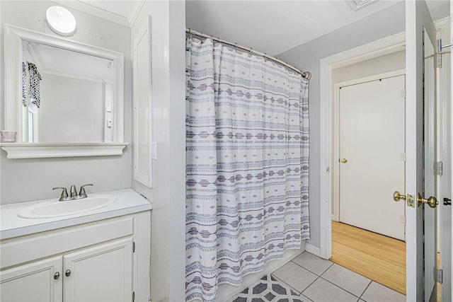 full bathroom with a shower with curtain, vanity, and tile patterned flooring