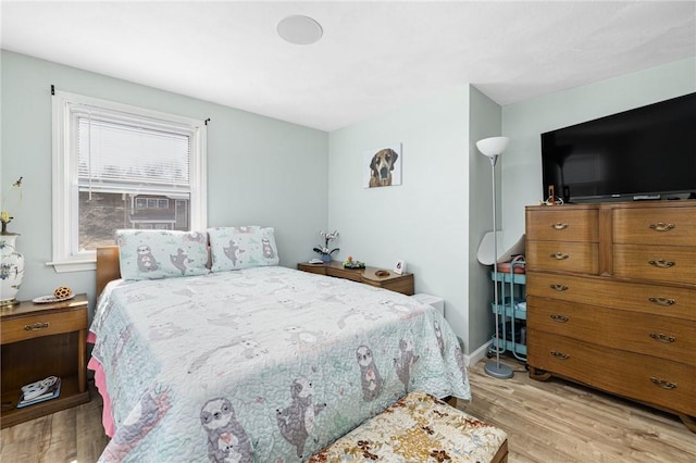 bedroom featuring light wood-style floors and baseboards