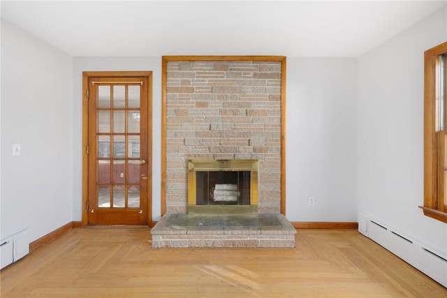 unfurnished living room featuring a baseboard heating unit, a fireplace, baseboards, and baseboard heating